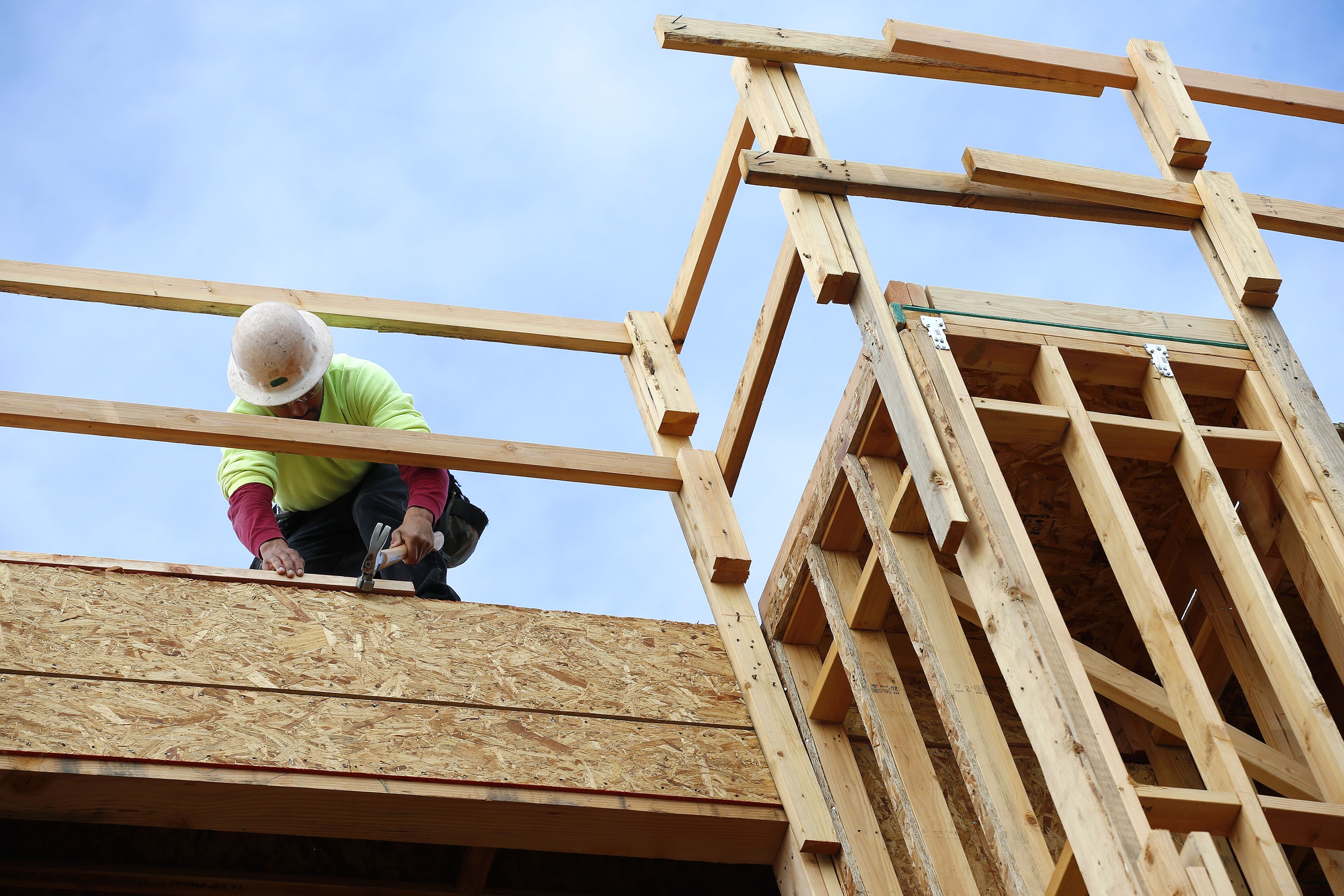 A builder works on a new apartment building under construction builders