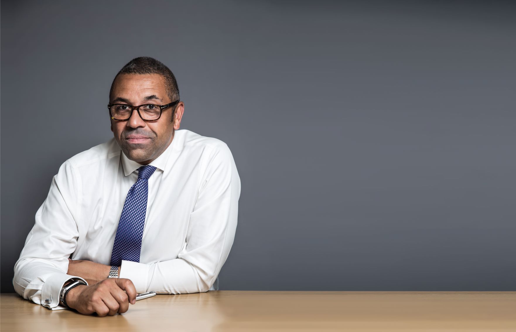 James Cleverly, Conservative MP for Braintree and Conservative Party Chairman James Cleverly sits at one end of a long table, holding a pen