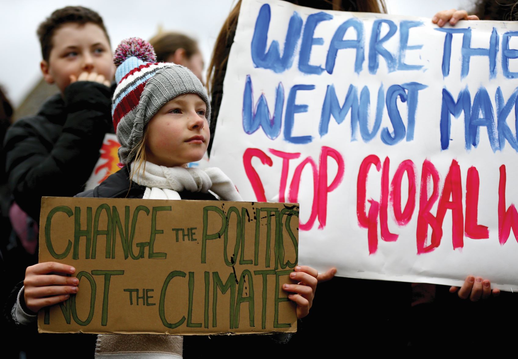 Students take part in a global school strike for climate change in Canterbury, Kent A young girl holds a sign saying
