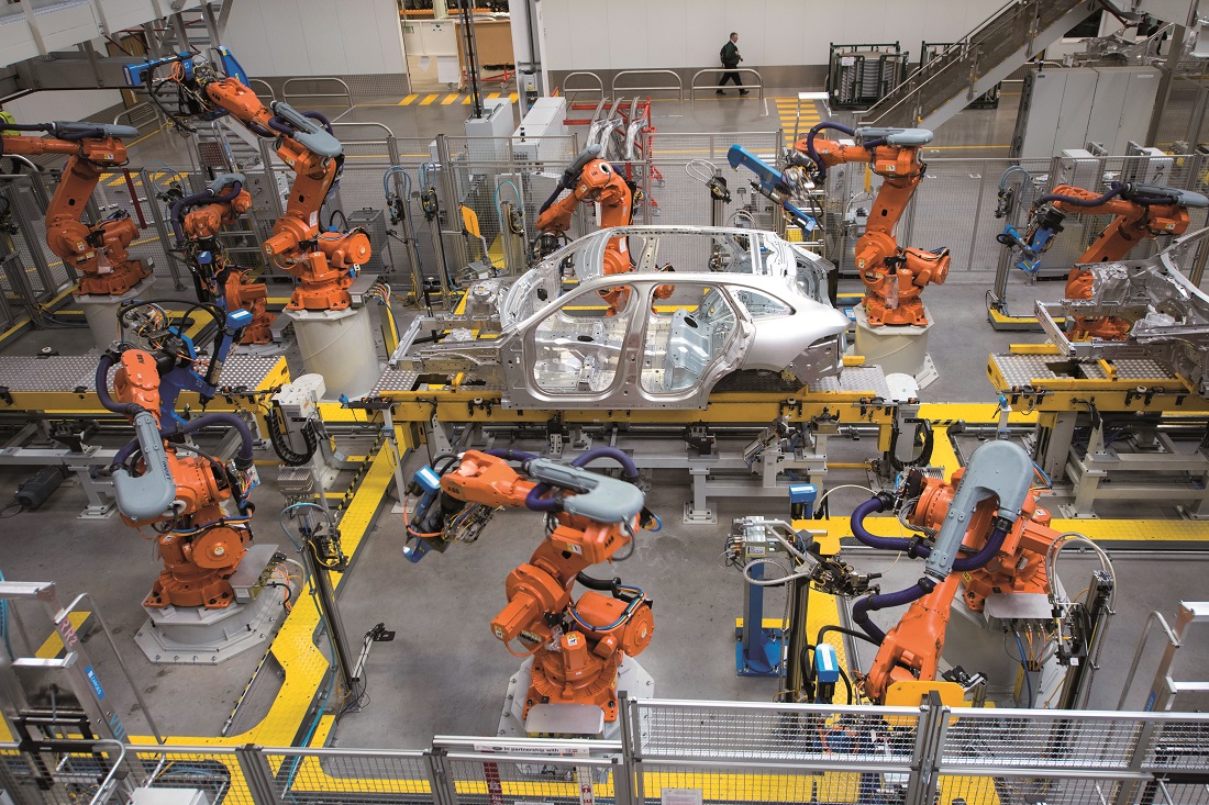 Robotic arms rivet car panels together Robotic arms rivet car panels together