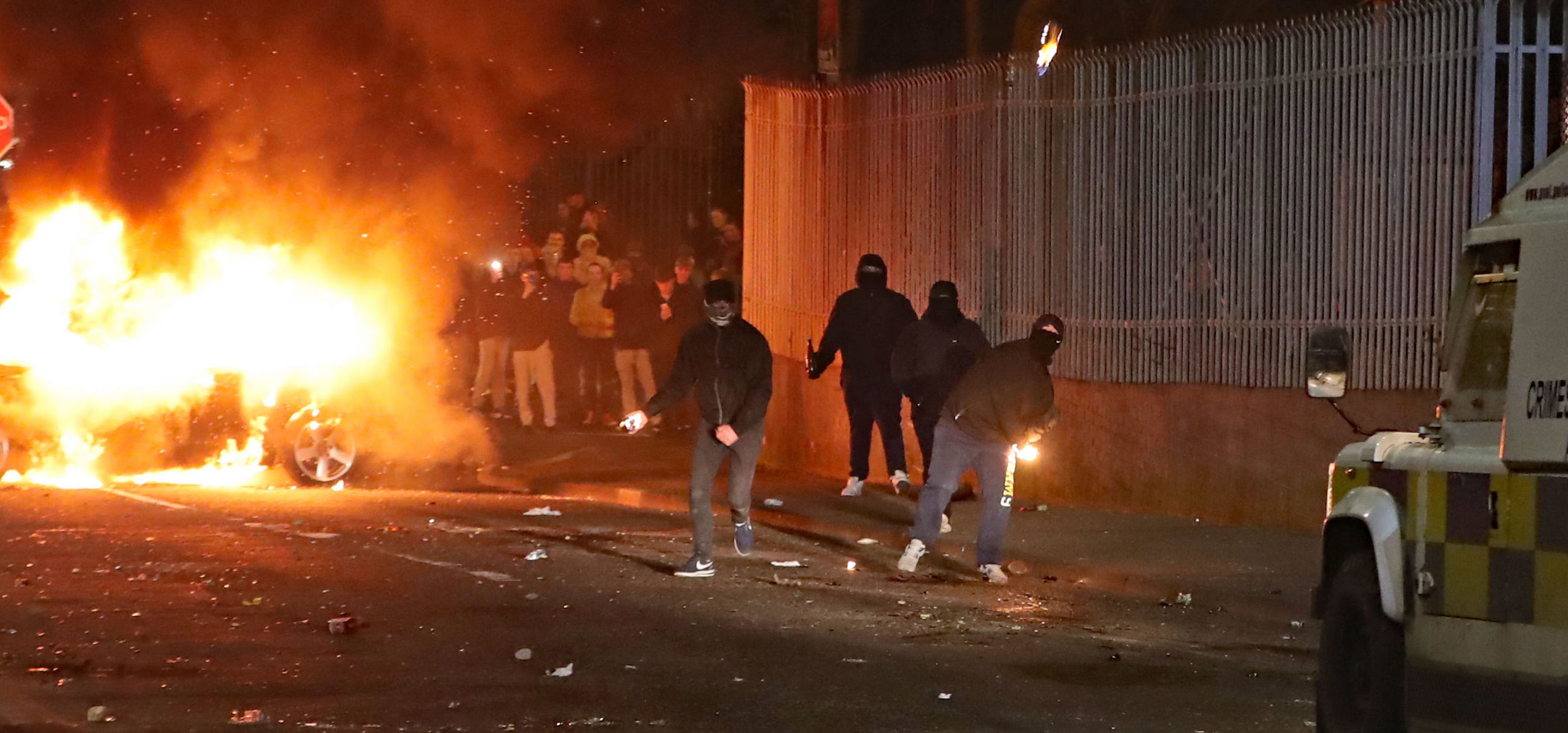 Petrol bombs are thrown at police in Creggan, Londonderry. Petrol bombs are thrown at police in Creggan, Londonderry.