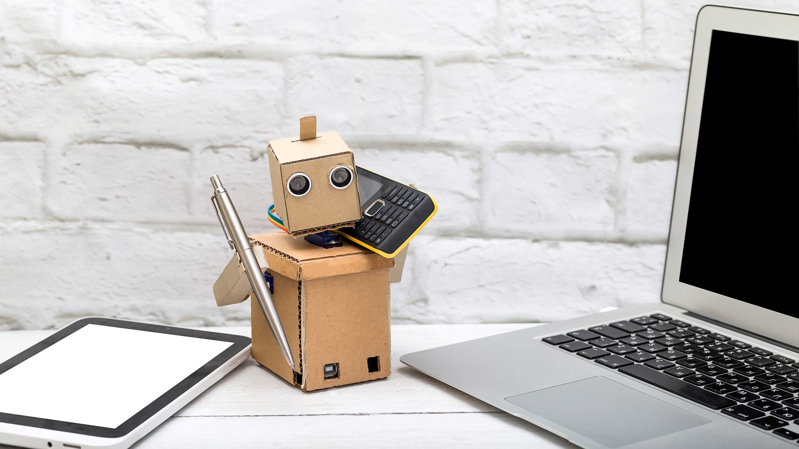 cardboard robot on phone