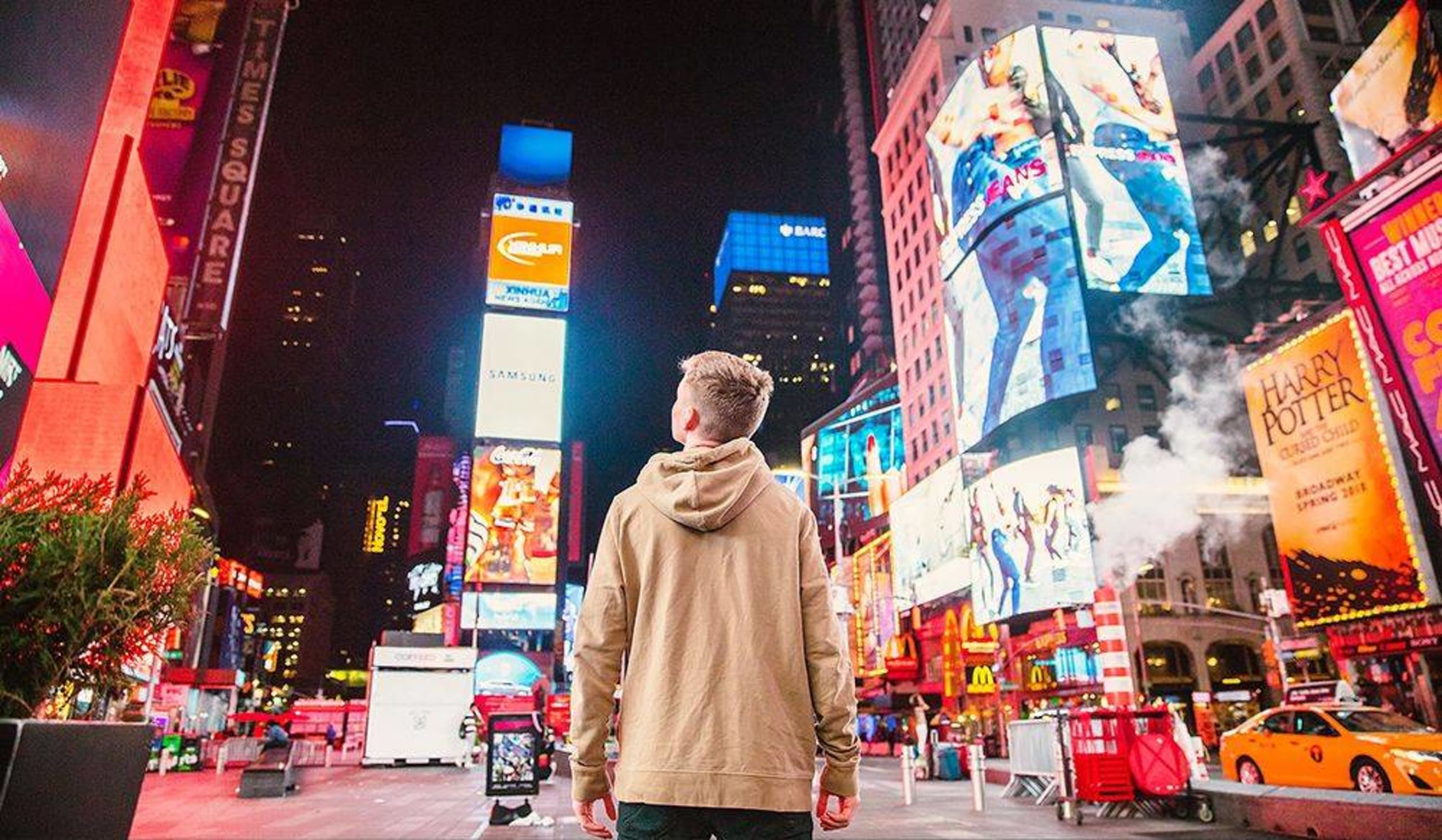 young man in a lit up big city