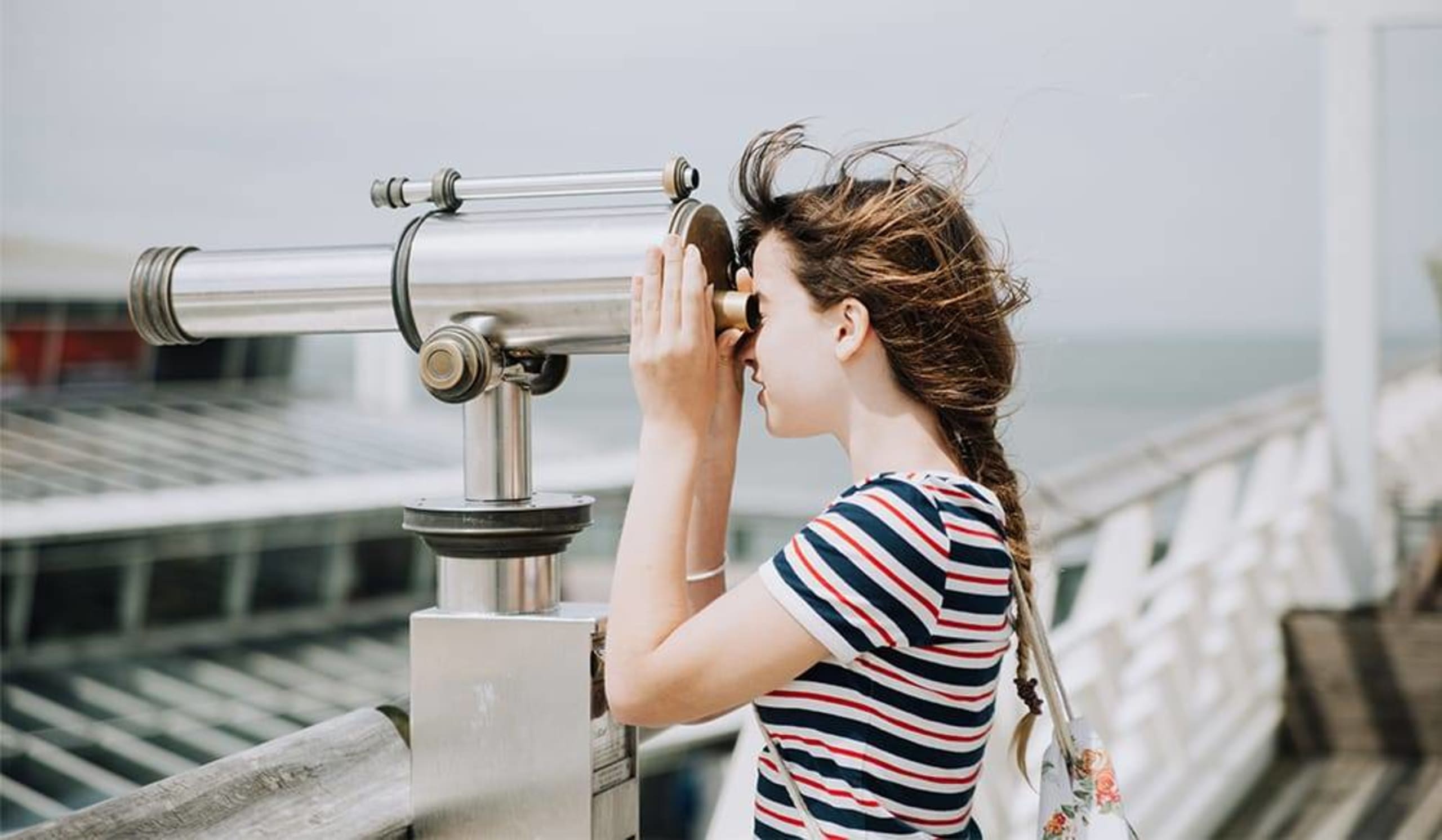 young girl looking through a scenic viewer