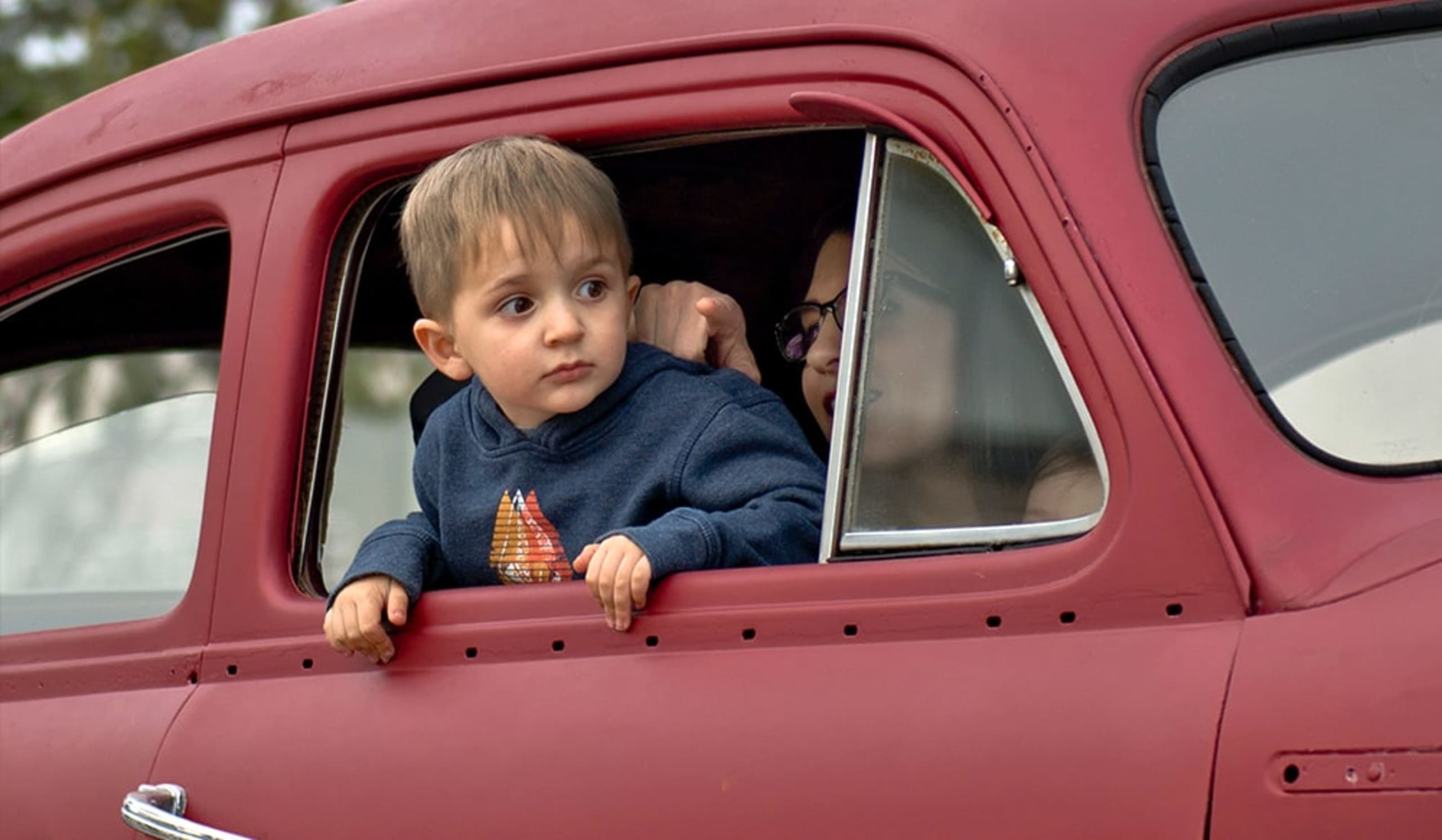 little boy looking out a car window