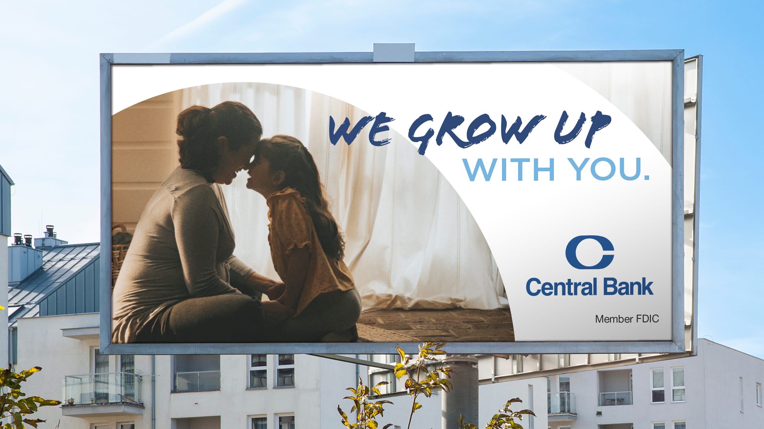 a central bank "we grow up with you" billboard depicting a mother and daughter smiling