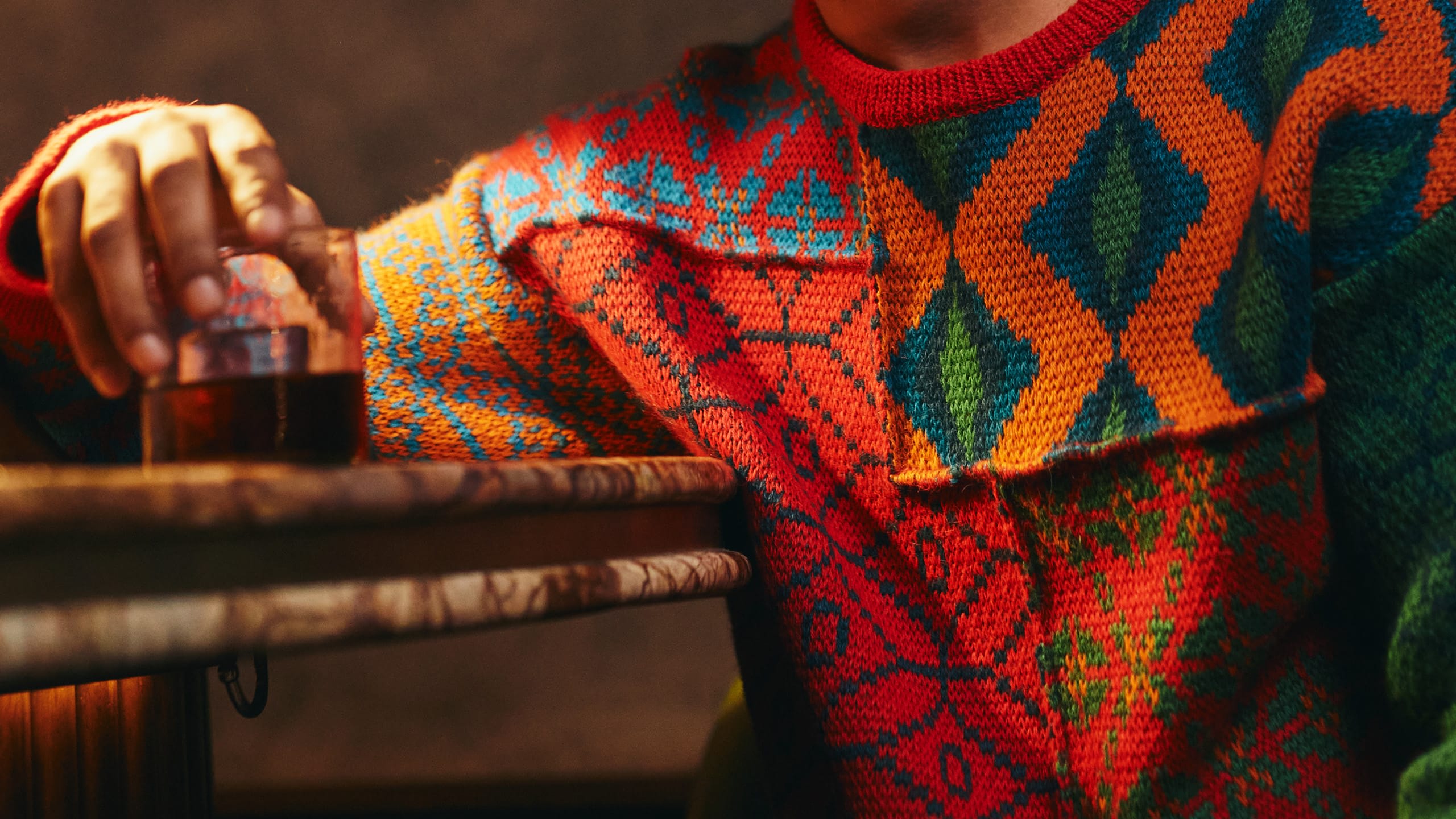 man in sweater holding whisky