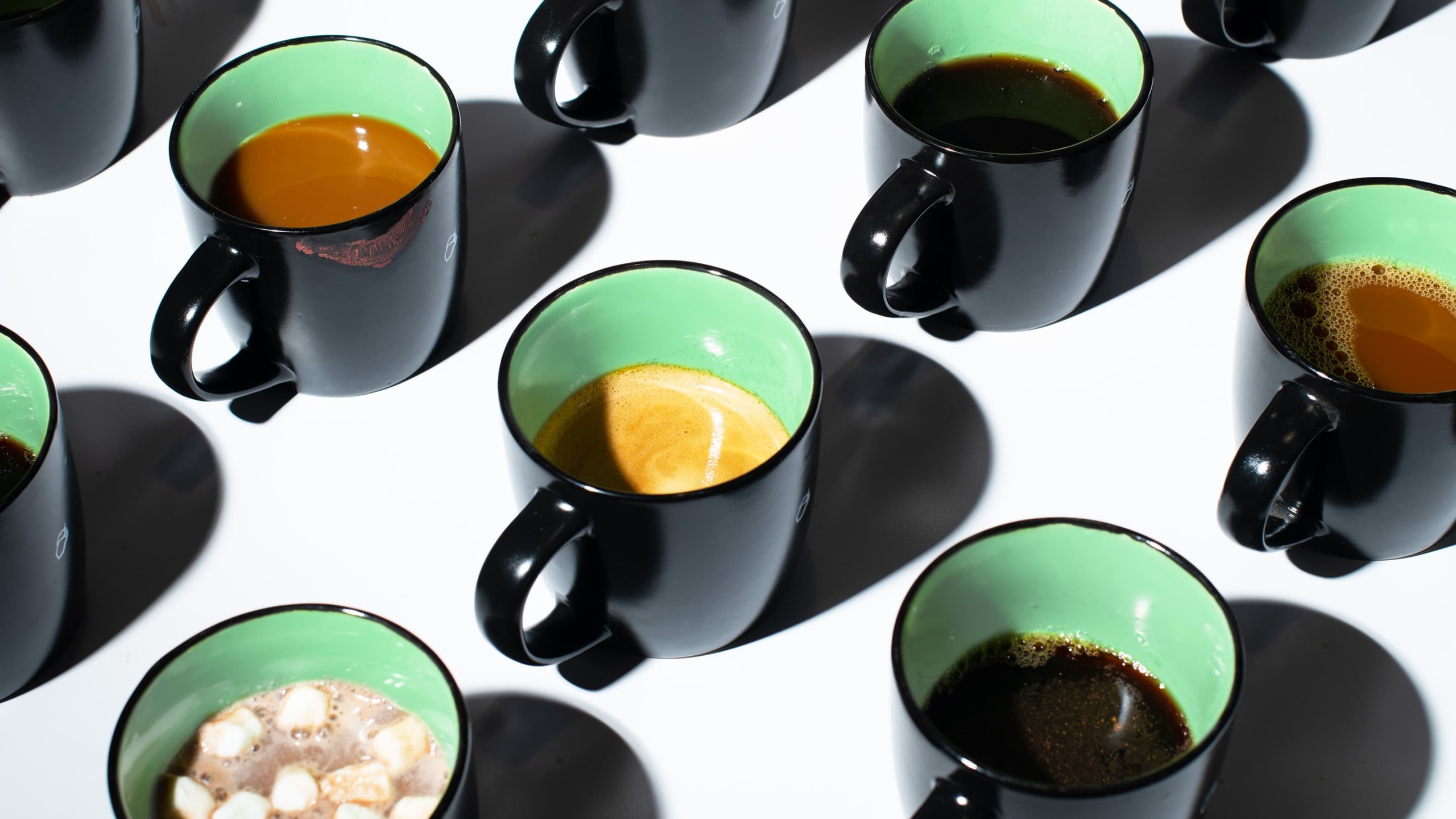 group of coffee mugs on white surface