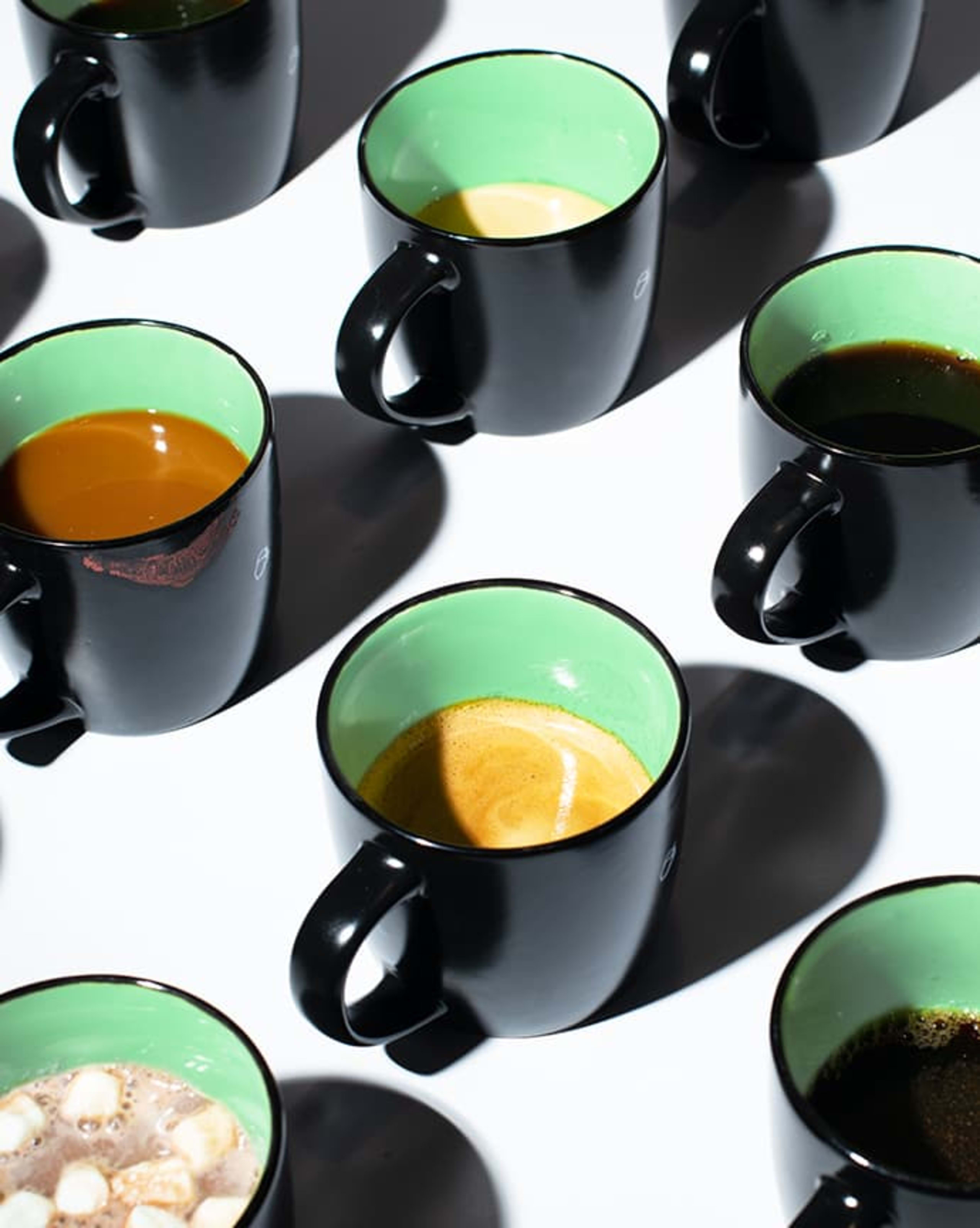 group of coffee mugs on white surface