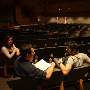 Divinity student who is discussing the bible with congregants after church service