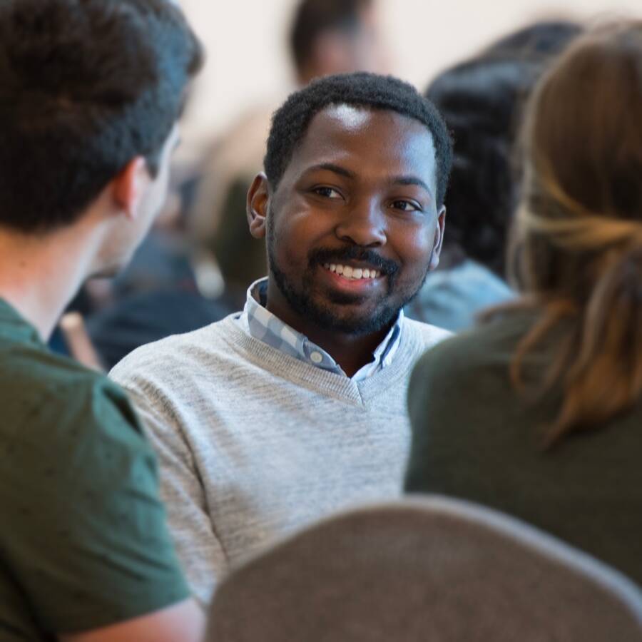 Man smiles in the conversation