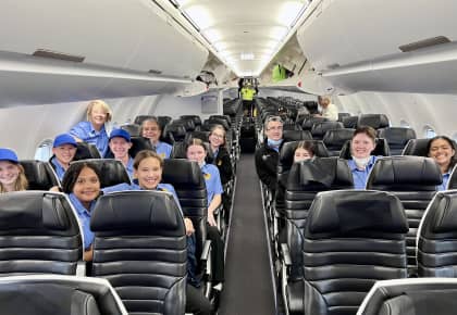 Anzac tour students sitting on an aeroplane