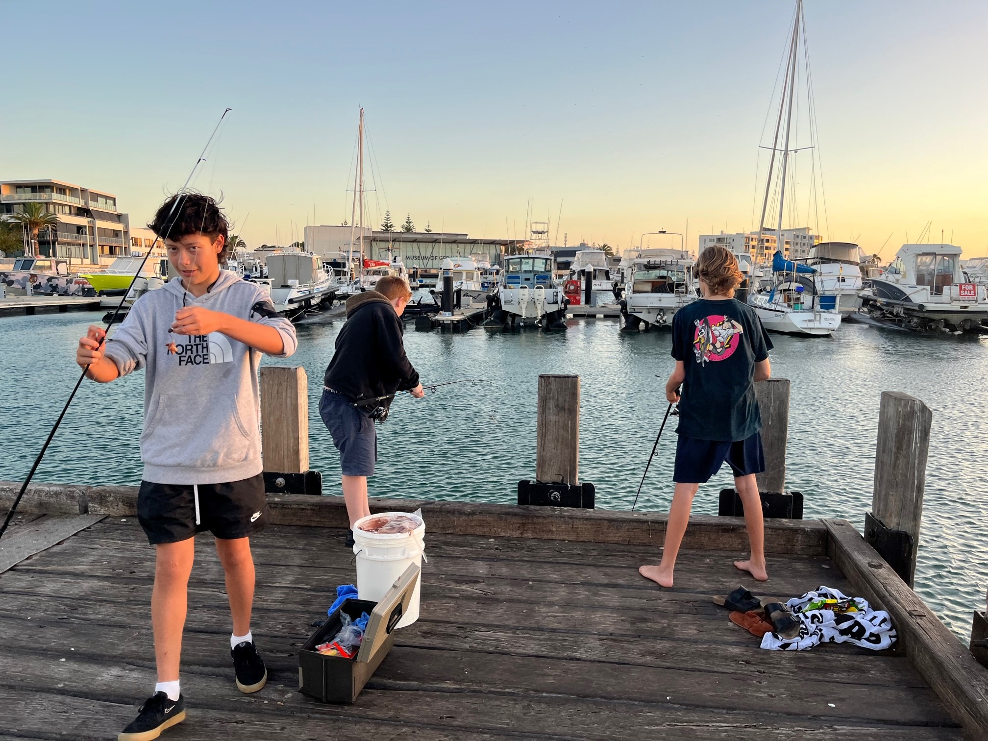 Boys fishing off the pier