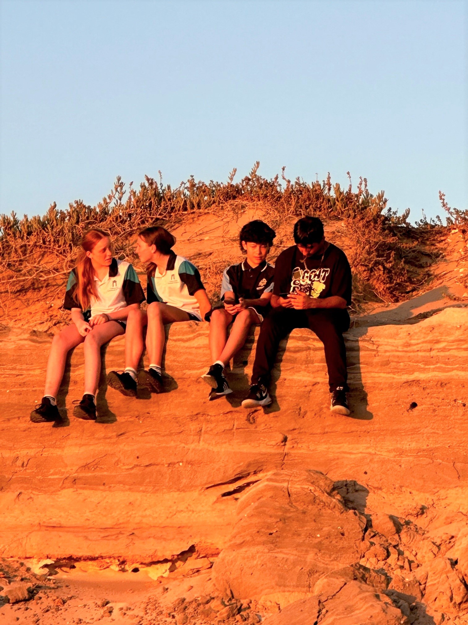 Students sitting together in the sunset