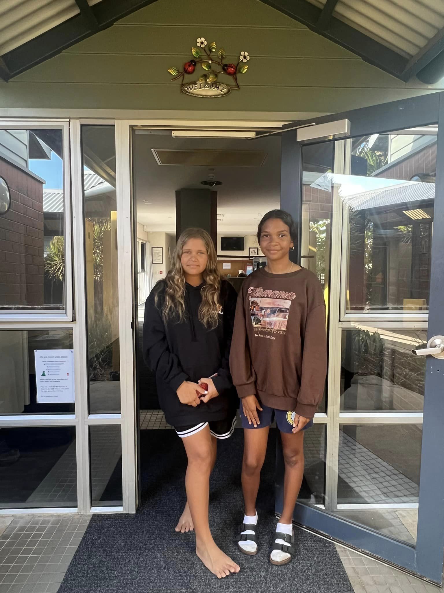 Girls standing outside Dellahale girls' boarding house