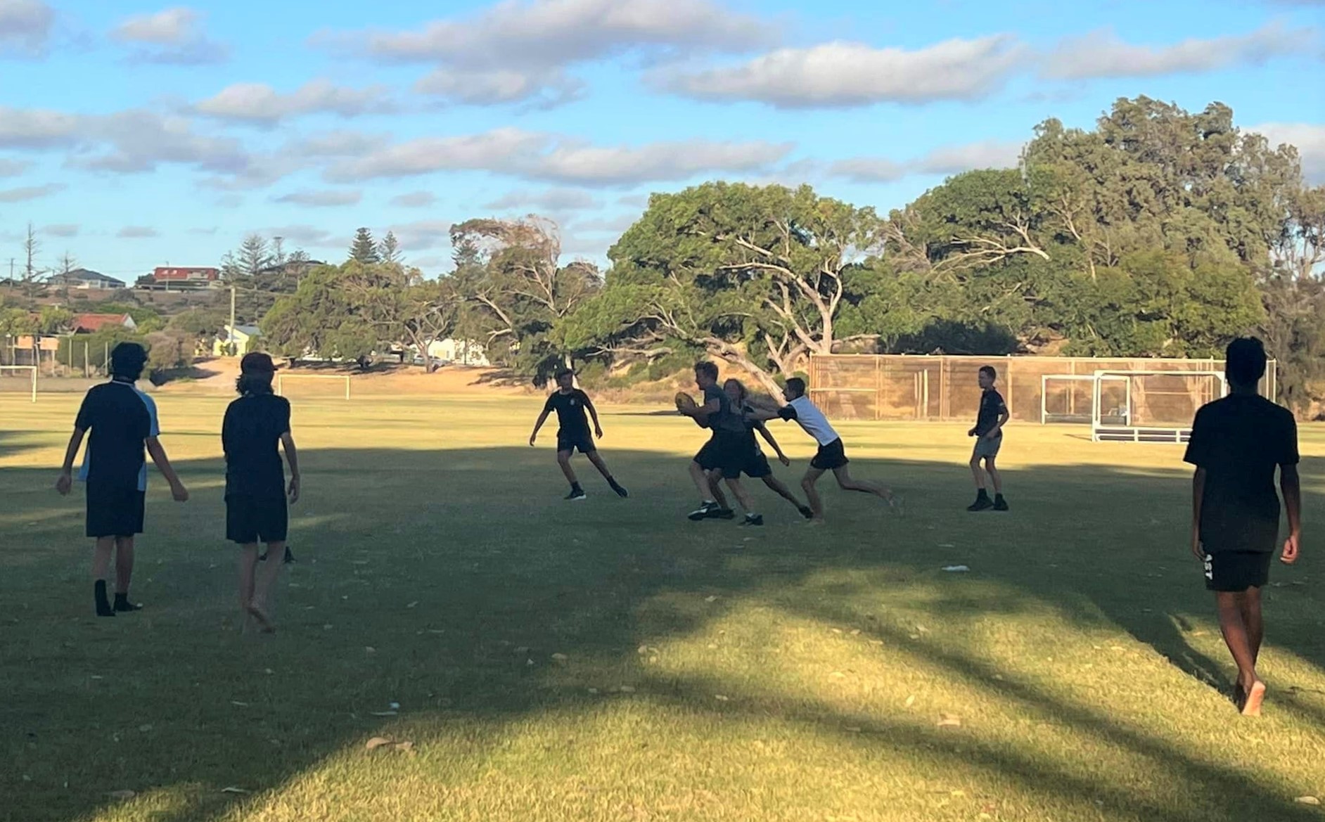 Children playing footy on the oval