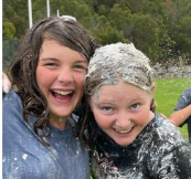 Pic of 2 girls having fun on the soapy slip-and-slide