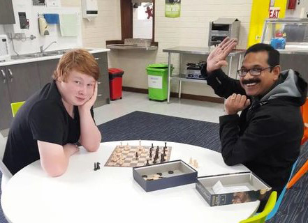 Northam Residential College student playing chess with a staff member