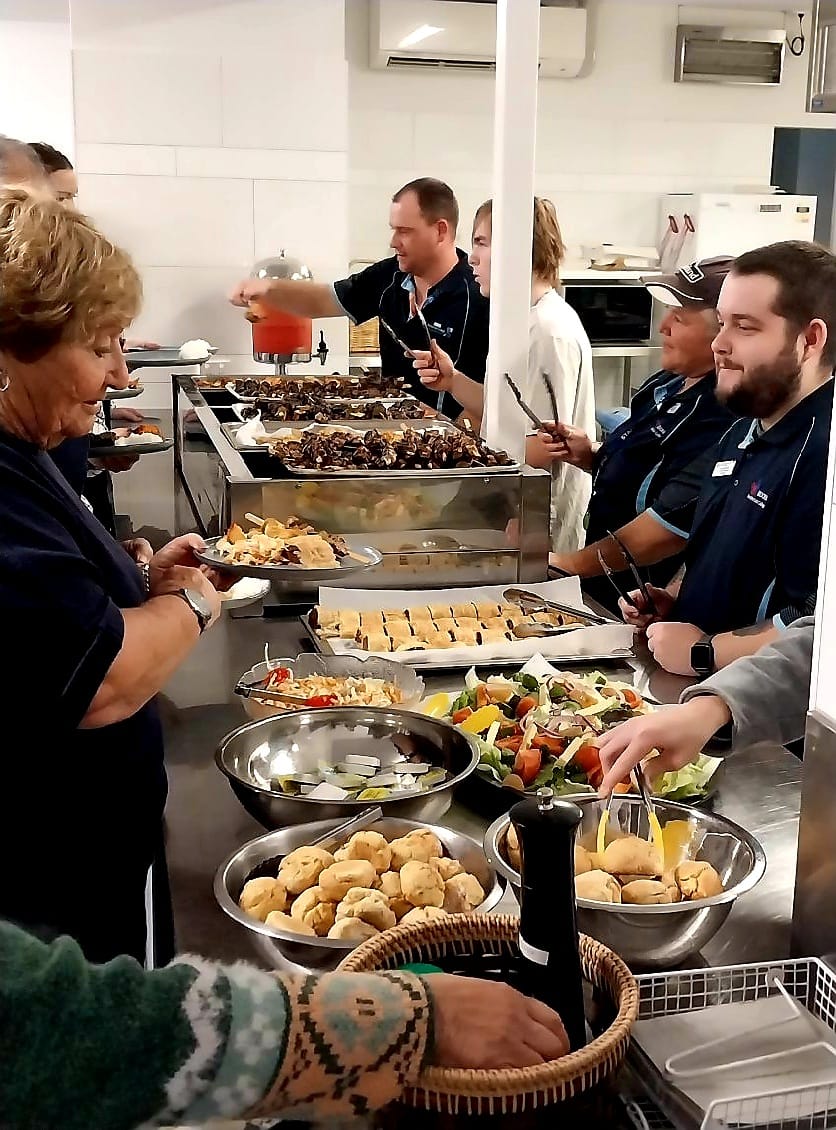 Moora residential college staff serving food to boarders