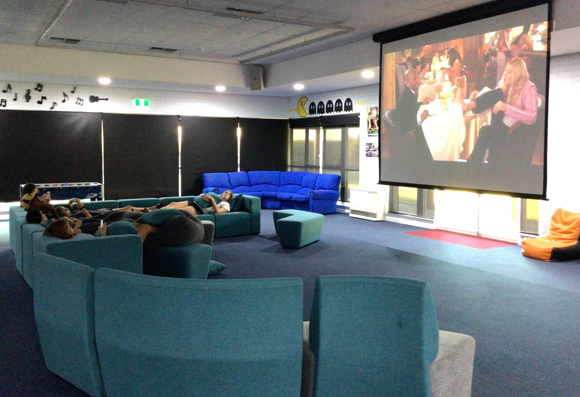 Narrogin Residential College boarders enjoying a movie projected on a large screen