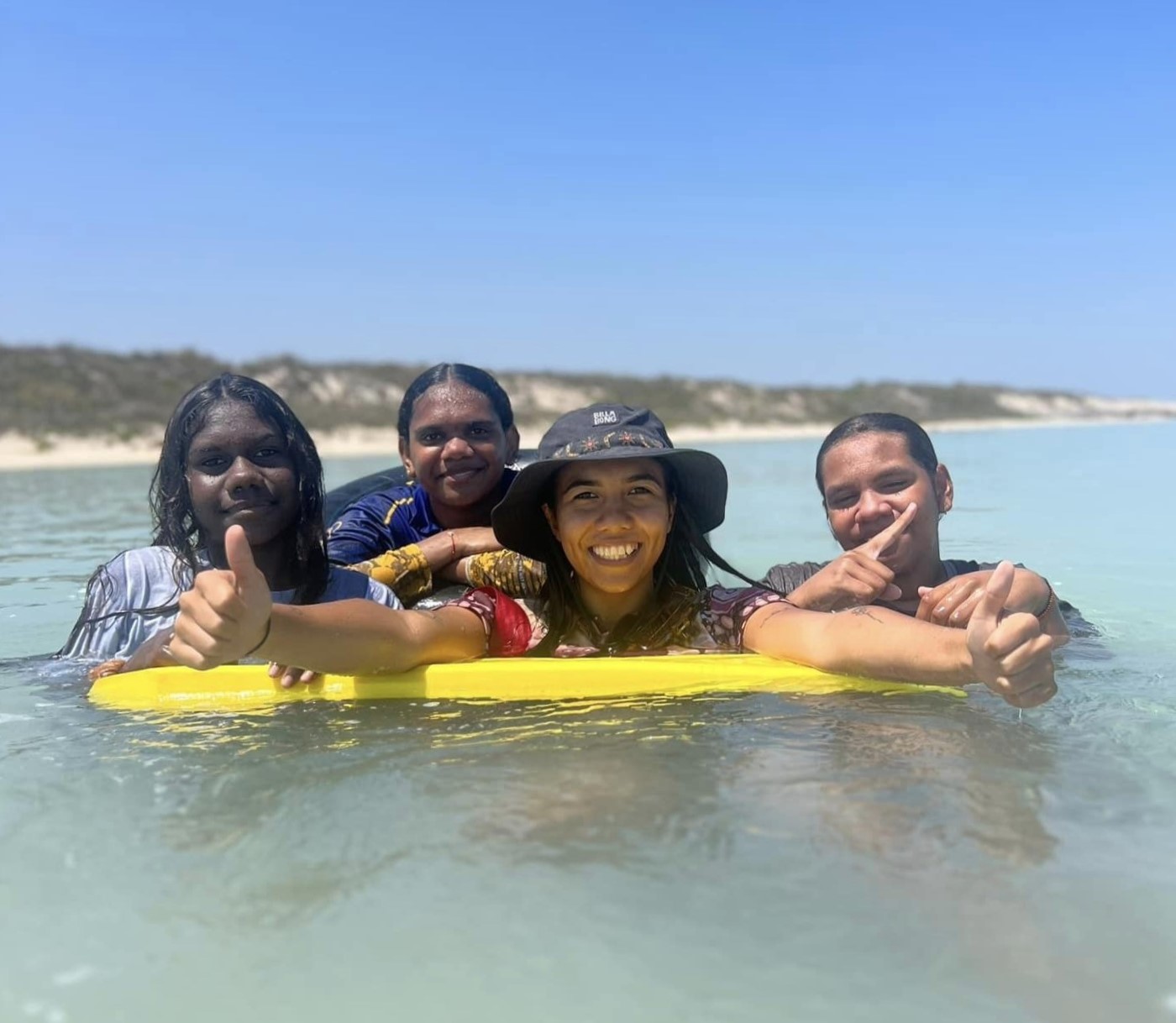 Boarding supervisor and students swimming in the ocean