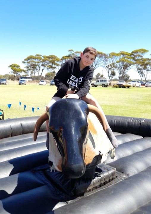 Northam Residential College boarder on a bucking bull ride at the local show