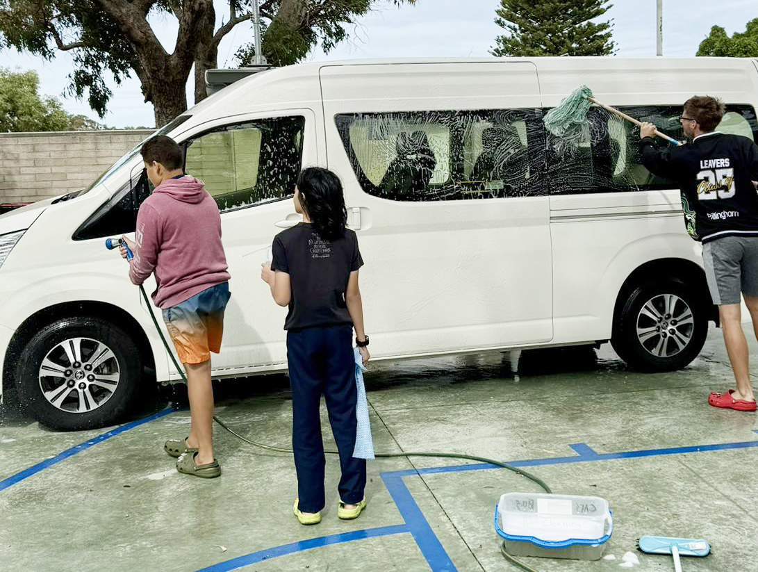 City Beach Residential College boarders cleaning the college bus