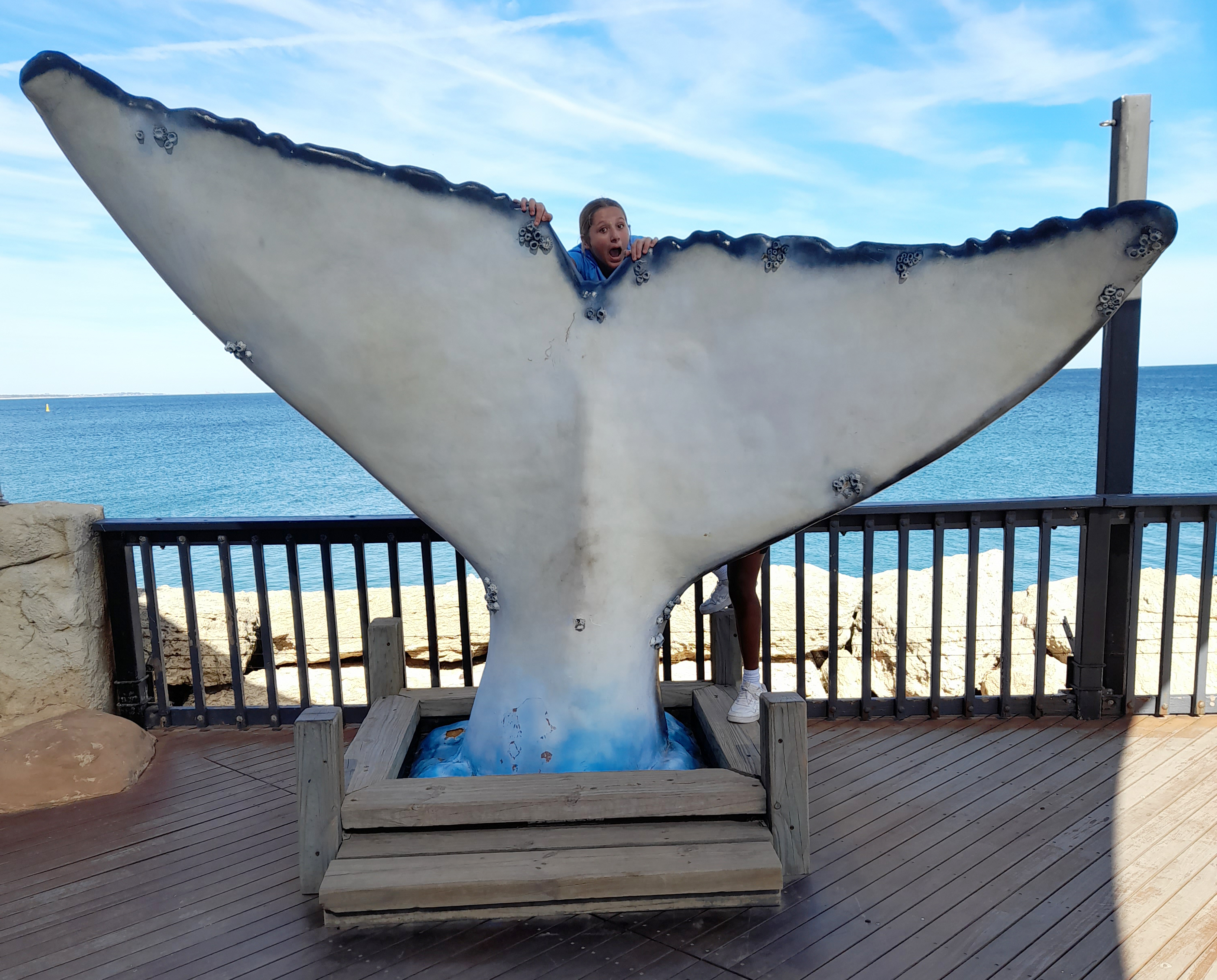 Boarder from Northam Residential College standing behind an enormous whale tail sculpture