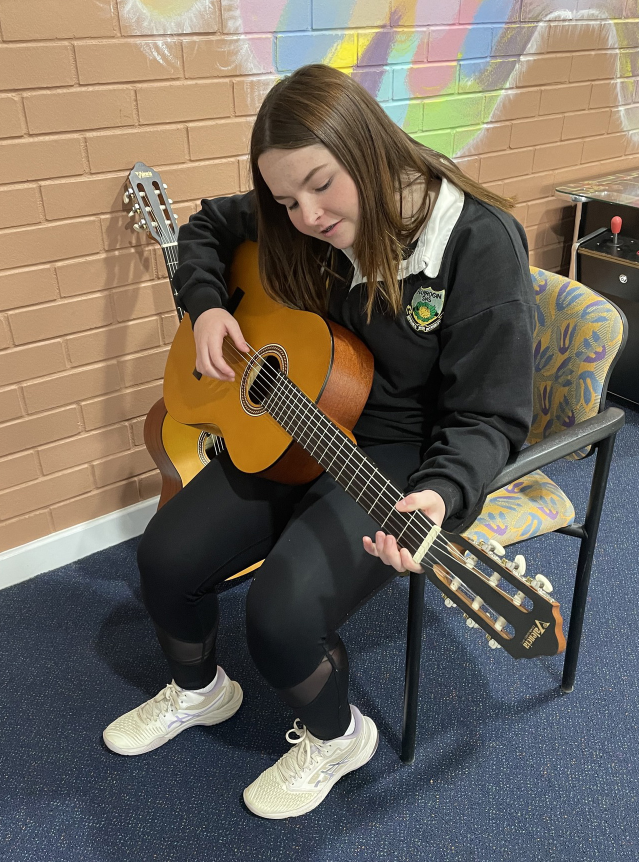 Narrogin Residential College boarder playing guitar