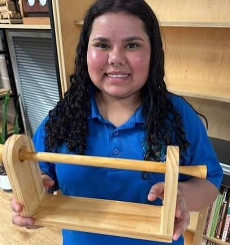 Boarder from Broome Senior High school proudly displaying her woodwork creation