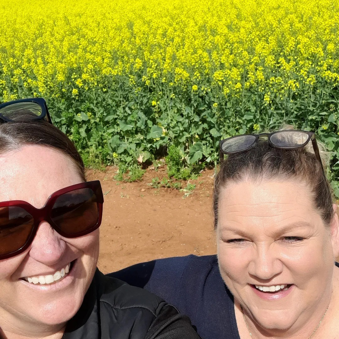 2 supervisors from Northam Residential College standing in a yellow canola field