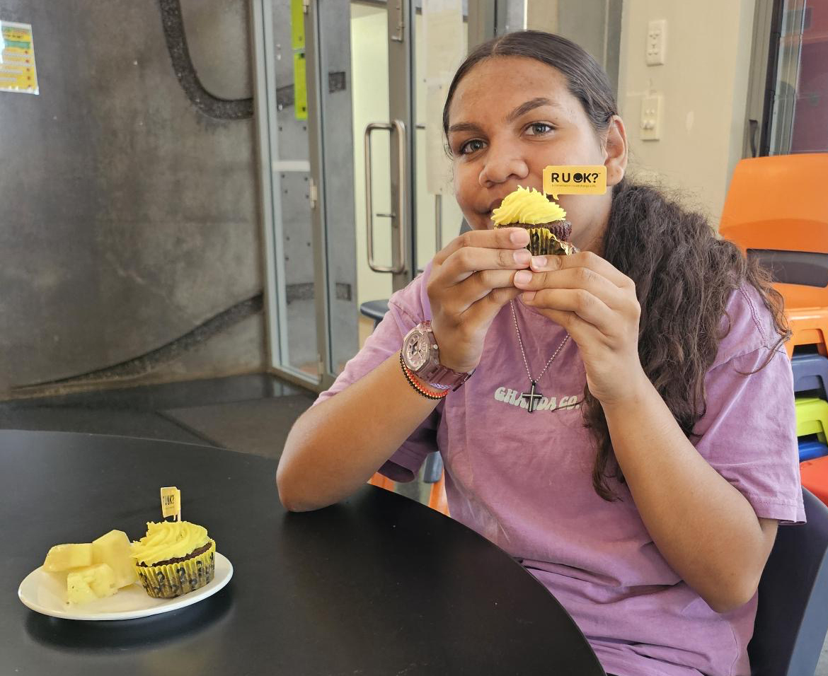 Boarder from Broome Residential College holding an RUOK Day cupcake