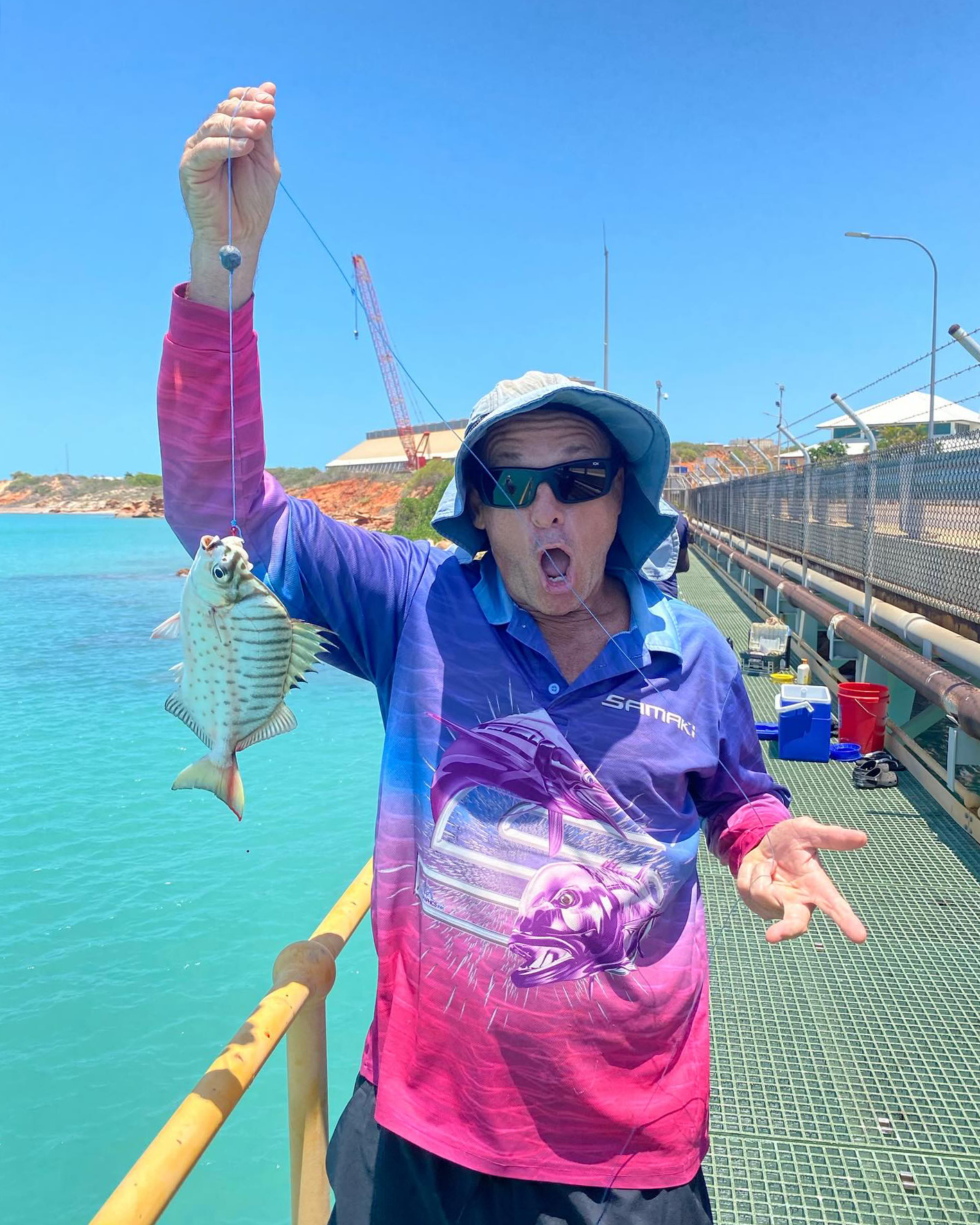 Broome Residential College boarding supervisor with a fish he just caught