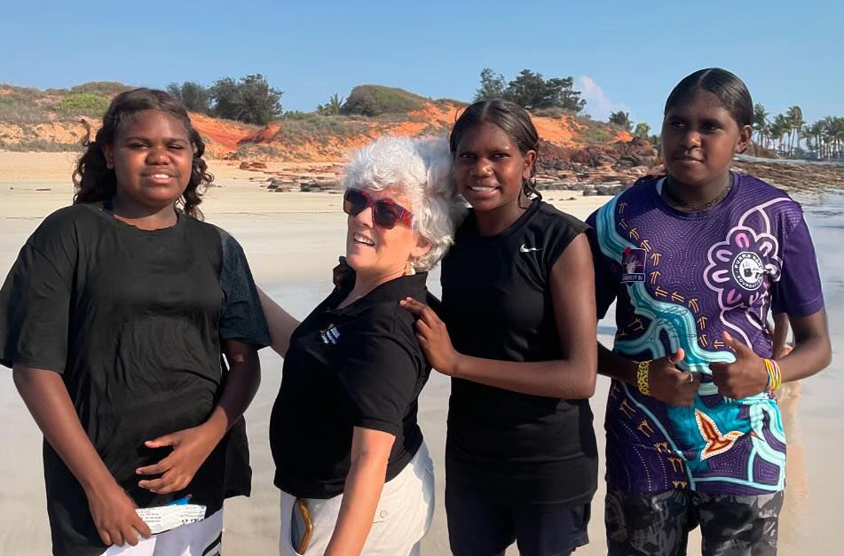 Broome Residential College supervisor with boarders at the beach