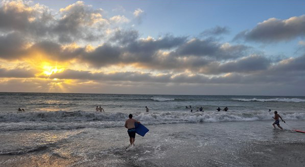 Boarders from Geraldton Residential College enjoying a beach swim at sunset