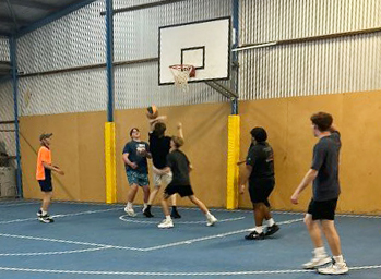 Boarders from Merredin Residential College playing basketball in the college indoor gym