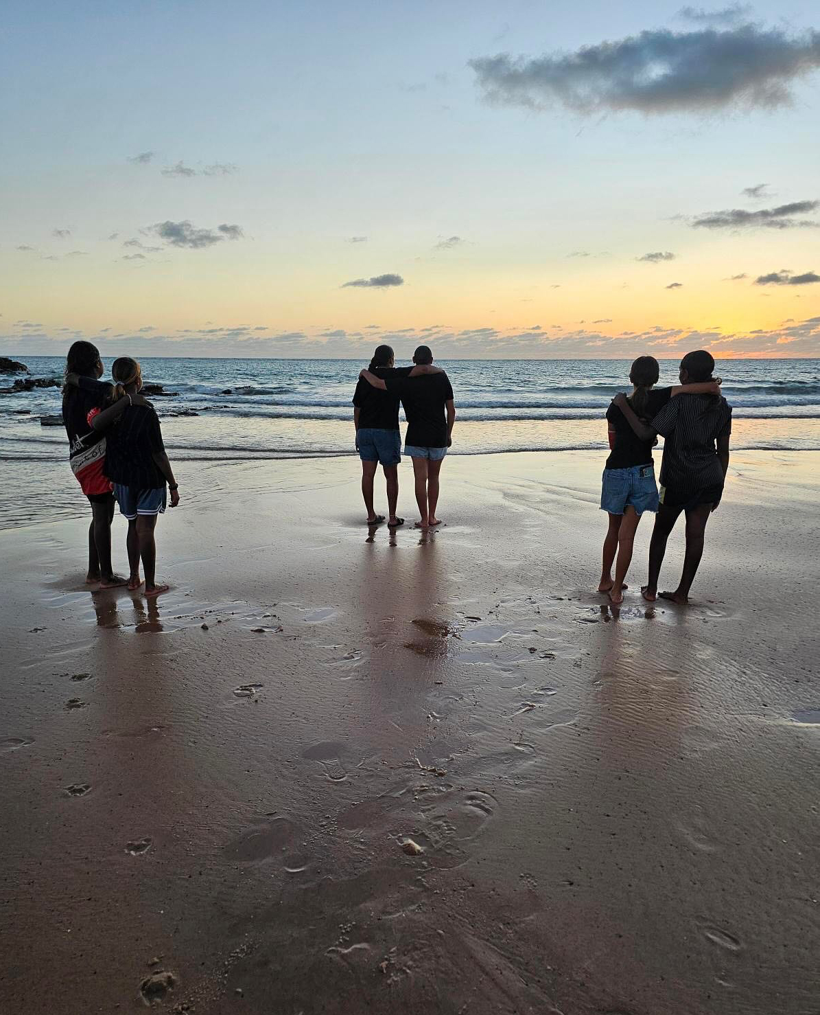 Broome Residential College boarders watching the sunset on the beach