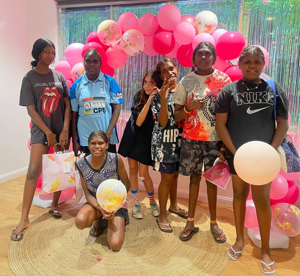 Broome Residential College girls standing under a ballon arch