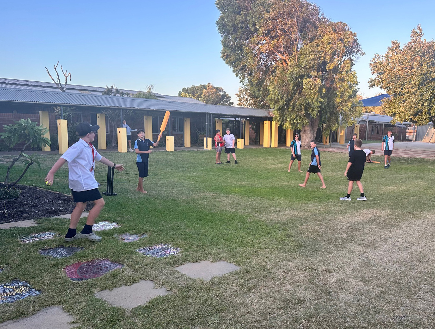 Geraldton Residential College boarders playing cricket on the college lawn