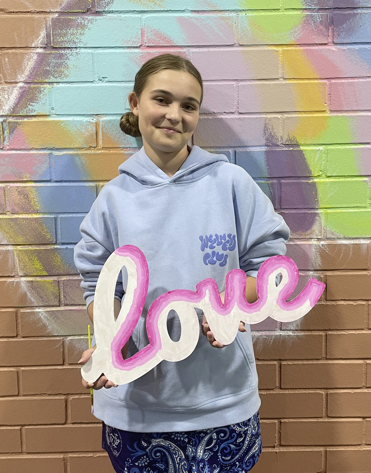 Narrogin Residential College boarder holding a 'love' sign