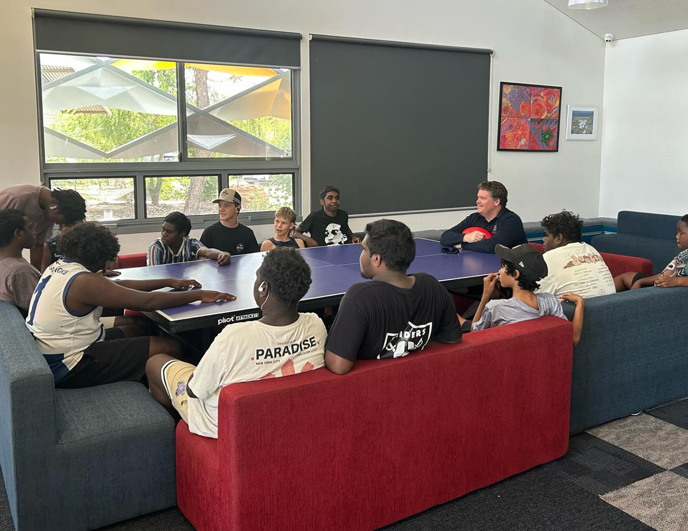 Group of boys from Broome Residential College all sitting around a large table having a group discussion