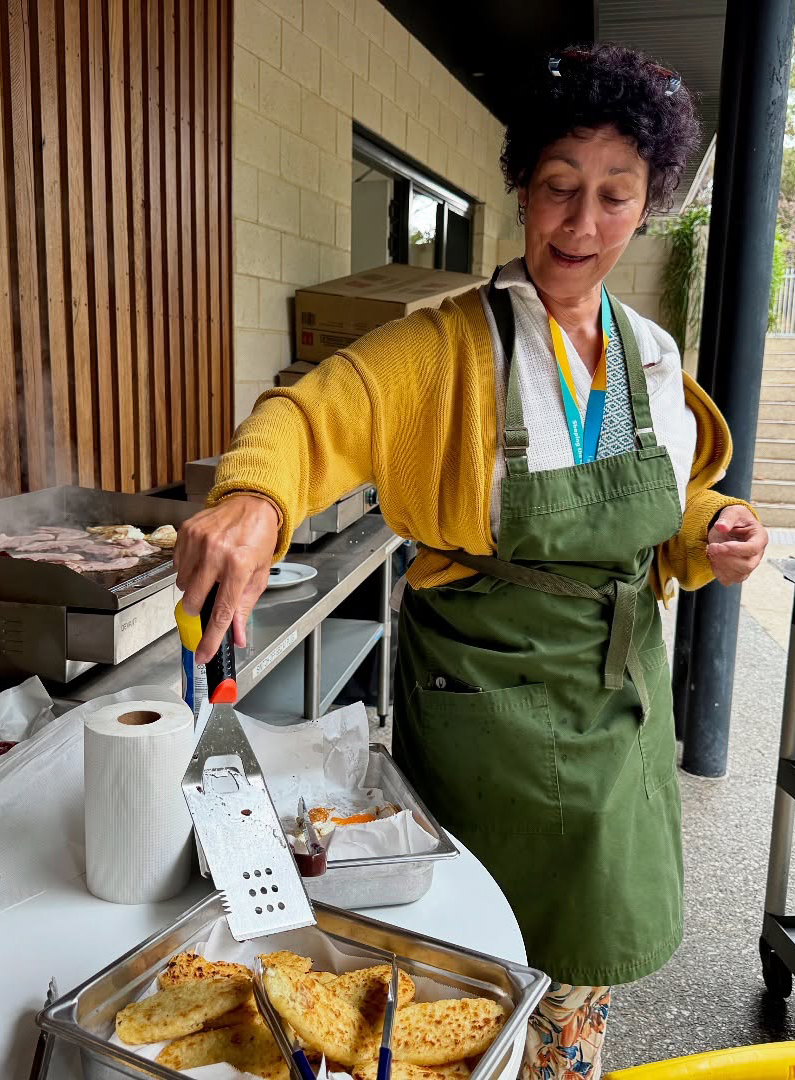 City Beach Residential College boarding supervisor cooking up a BBQ brecky feast