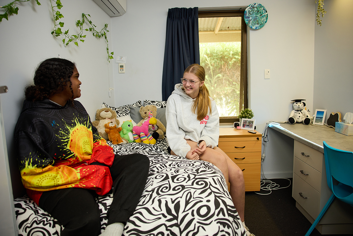2 Northam Residential College boarders sitting in a standard college bedroom