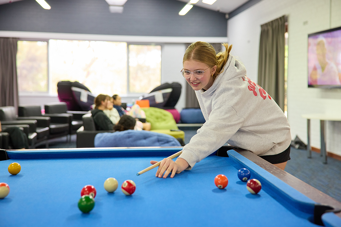 Northam Residential College boarder playing pool on the college pool table