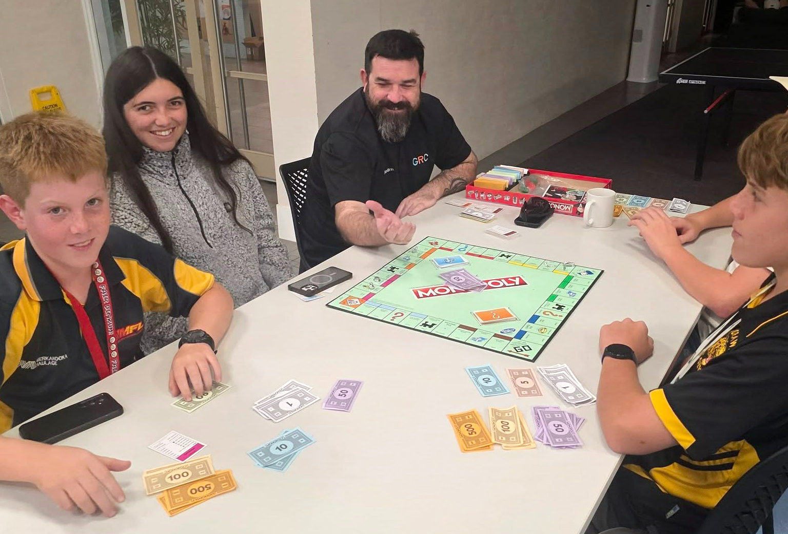 Geraldton Residential College boarding supervisor playing monopoly with a group of boarders.