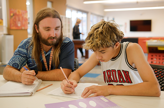 Boarding supervisor at Esperance Residential College helping a student with homework
