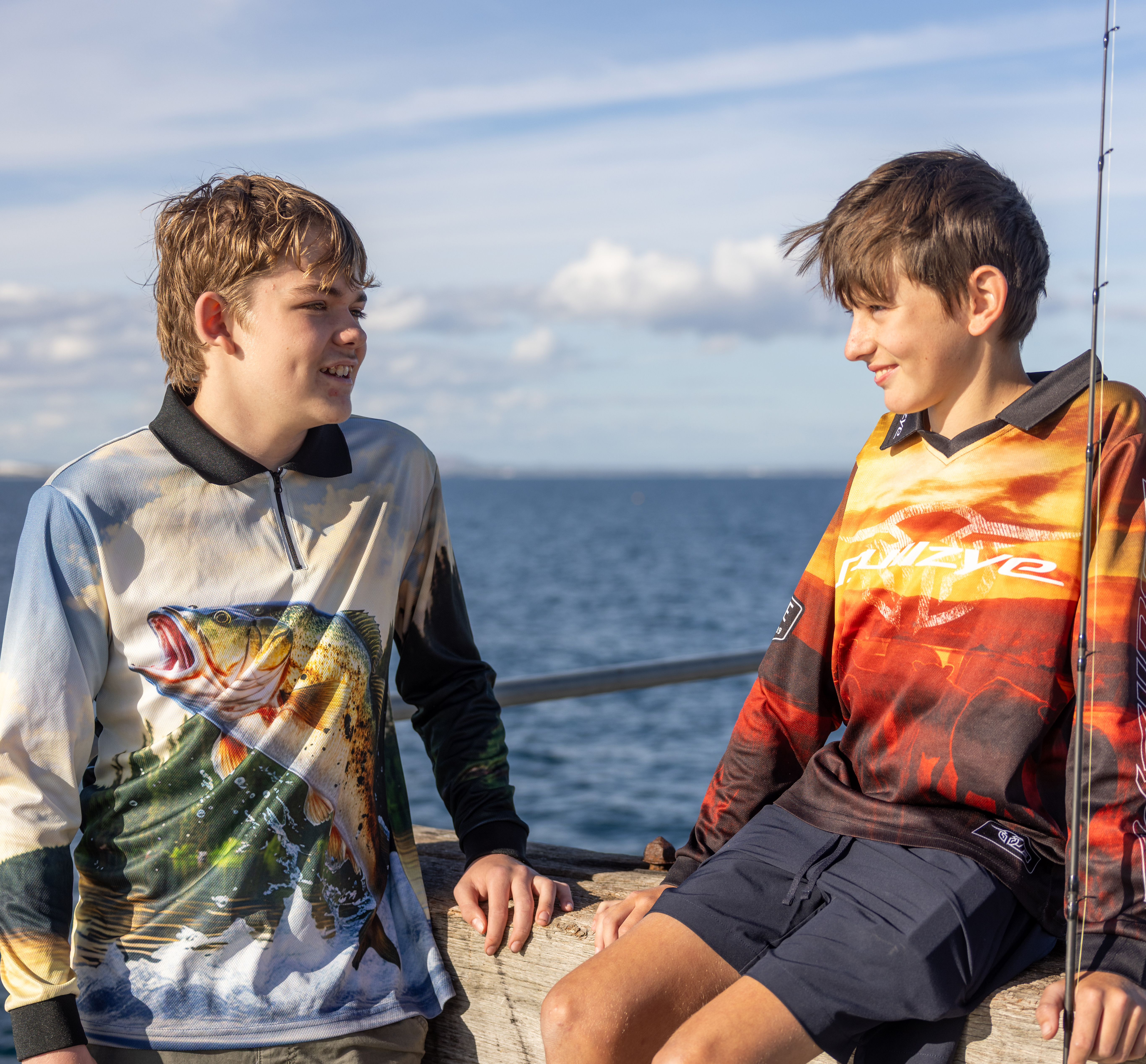 2 boys from Esperance Residential College with fishing rods at the beach