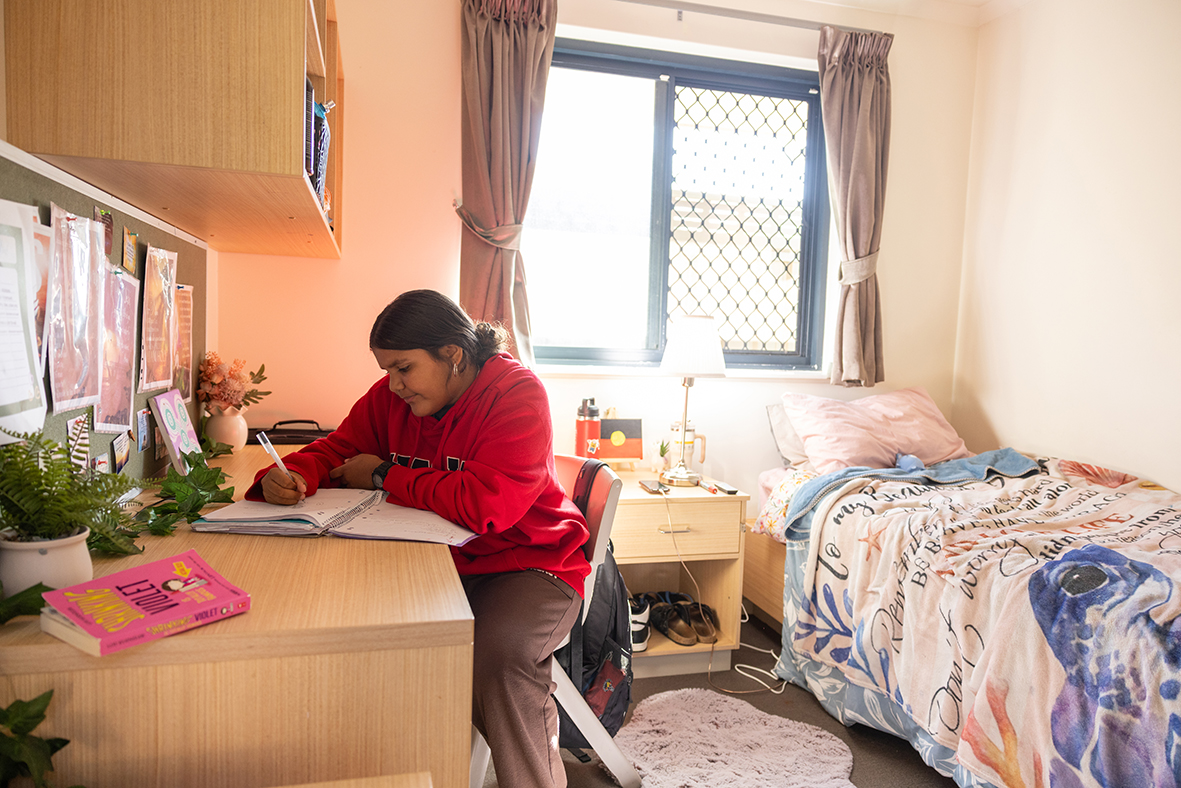 A boarder studying at desk in her bedroom at Esperance Residential College.
