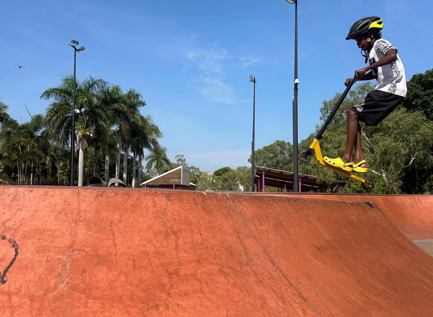 A boarder from Broome Residential College getting some air on his scooter at the local skate park