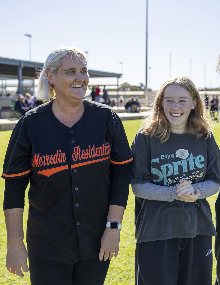 Merredin Residential College boarding supervisor smiling and walking with a boarder